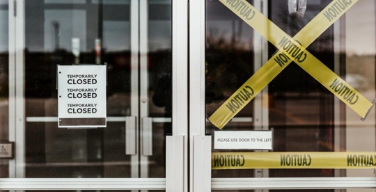caution tape in front of glass door